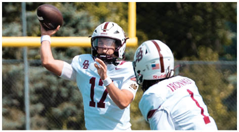 A football player wearing a blue and red jersey. Description generated by AI