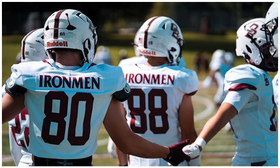 A football player wearing a blue and red jersey. Description generated by AI