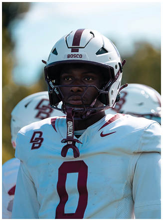 A football player wearing a blue and red jersey. Description generated by AI