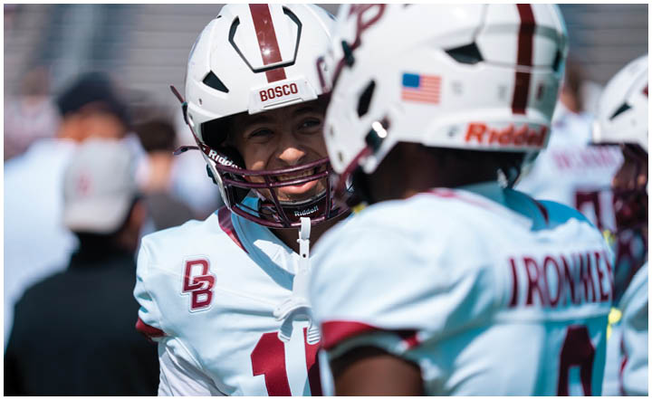 A football player wearing a blue and red jersey. Description generated by AI