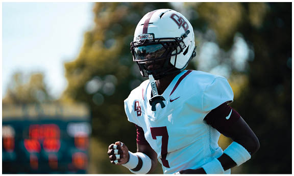 A football player wearing a blue and red jersey. Description generated by AI