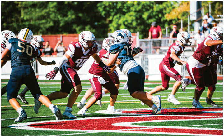 A football player wearing a blue and red jersey. Description generated by AI