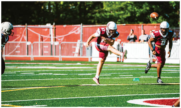A football player wearing a blue and red jersey. Description generated by AI