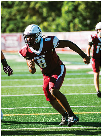 A football player wearing a blue and red jersey. Description generated by AI