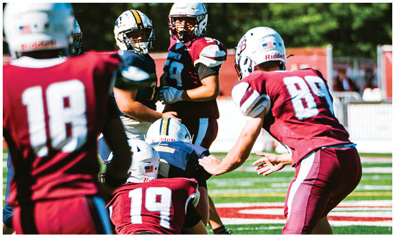 A football player wearing a blue and red jersey. Description generated by AI