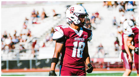 A football player wearing a blue and red jersey. Description generated by AI