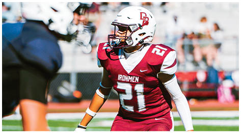 A football player wearing a blue and red jersey. Description generated by AI