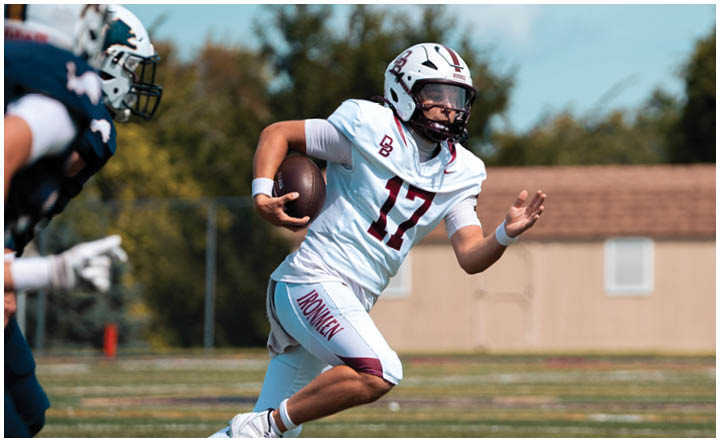 A football player wearing a blue and red jersey. Description generated by AI