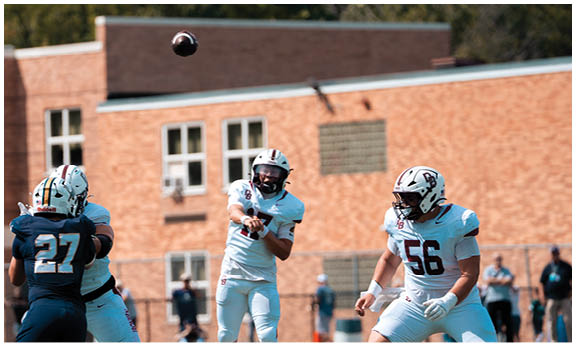 A football player wearing a blue and red jersey. Description generated by AI