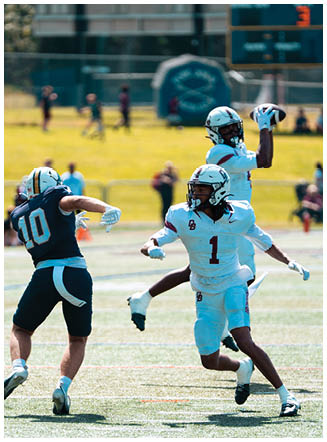 A football player wearing a blue and red jersey. Description generated by AI