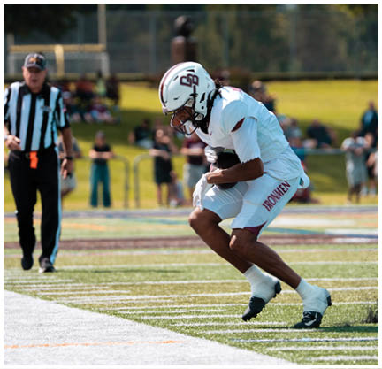 A football player running on the field. Description generated by AI