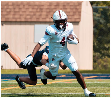A football player running on the field. Description generated by AI