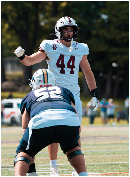 A football player wearing a blue jersey with the number 58 on it. Description generated by AI