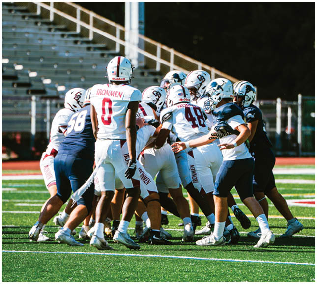 A football player wearing a blue and red jersey. Description generated by AI