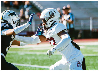 A football player wearing a blue and red jersey. Description generated by AI