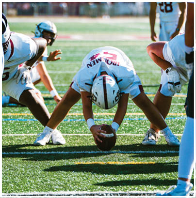 A football player wearing a blue and red jersey. Description generated by AI
