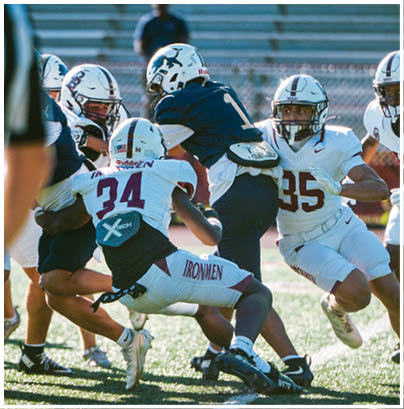 A football player wearing a blue and red jersey. Description generated by AI