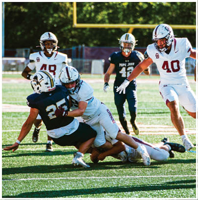 A football player wearing a blue and red jersey. Description generated by AI