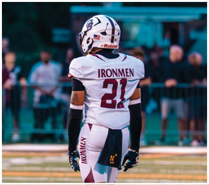 A football player running on the field. Description generated by AI
