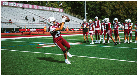 A football player wearing a blue and red jersey. Description generated by AI