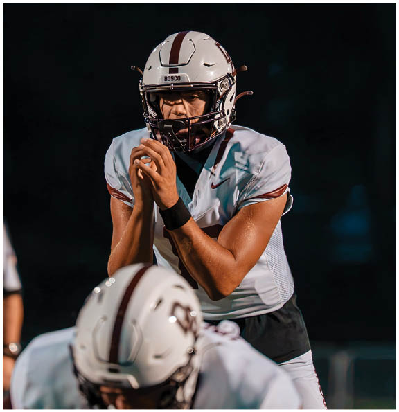 A football player wearing a blue and red jersey. Description generated by AI