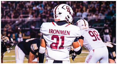 A football player wearing a blue and red jersey. Description generated by AI