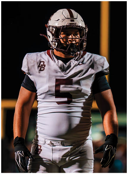 A football player wearing a blue jersey with the number 58 on it. Description generated by AI