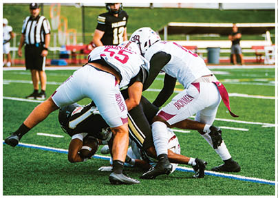 A football player wearing a blue and red jersey. Description generated by AI