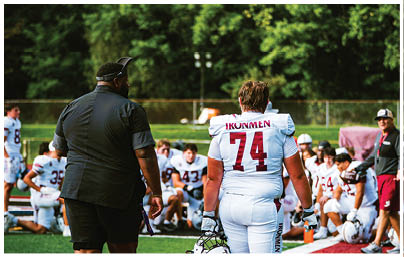 A football player wearing a blue and red jersey. Description generated by AI