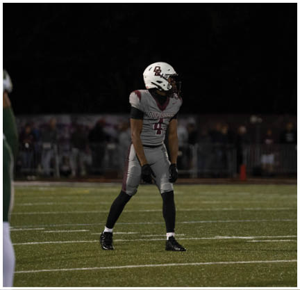 A football player running on the field. Description generated by AI