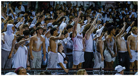 A football player wearing a blue and red jersey. Description generated by AI
