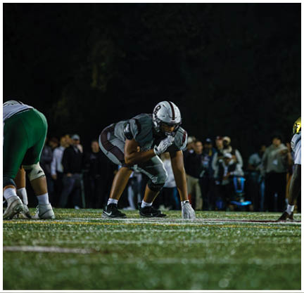 A football player running on the field. Description generated by AI