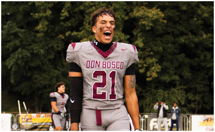A football player wearing a blue and red jersey. Description generated by AI