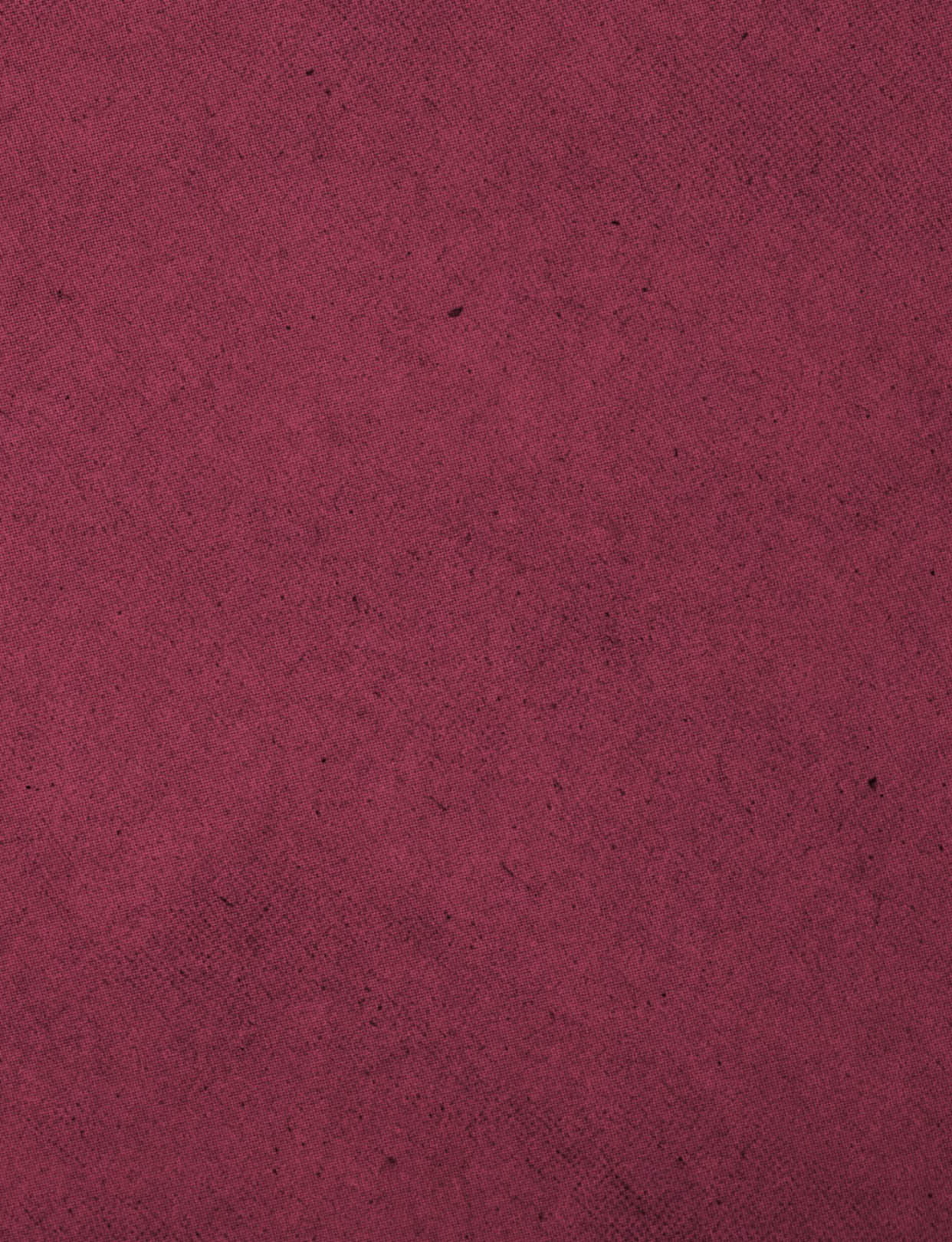 A red fabric with a pattern. Description generated by AI