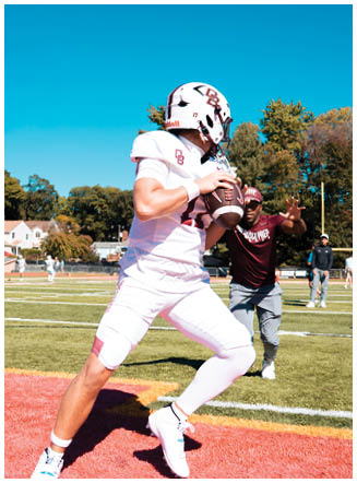 A football player wearing a blue and red jersey. Description generated by AI