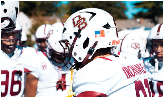 A football player wearing a blue and red jersey. Description generated by AI