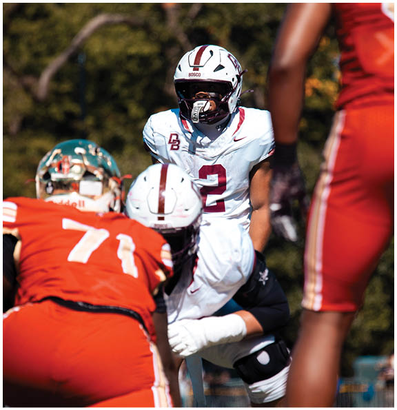 A football player wearing a blue and red jersey. Description generated by AI