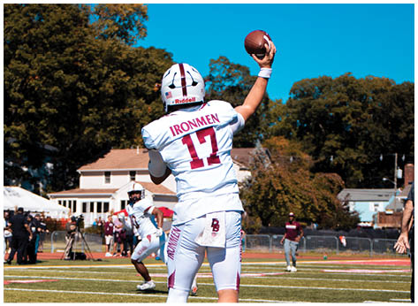 A football player wearing a blue and red jersey. Description generated by AI
