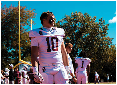 A football player wearing a blue and red jersey. Description generated by AI