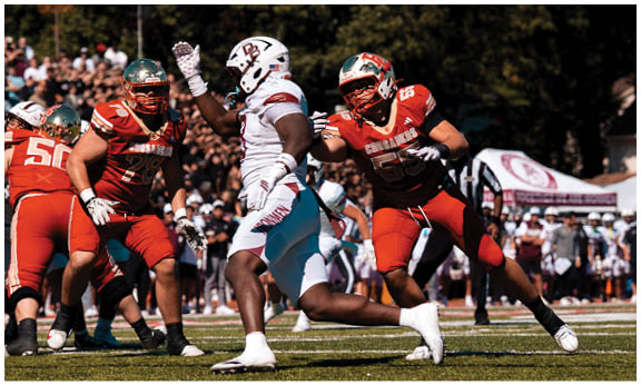 A football player wearing a blue and red jersey. Description generated by AI