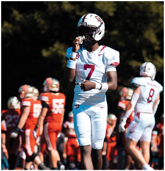 A football player wearing a blue and red jersey. Description generated by AI