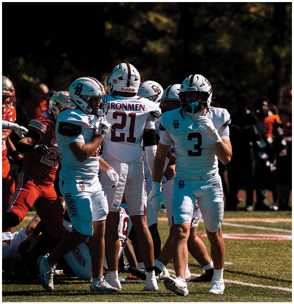 A football player wearing a blue and red jersey. Description generated by AI