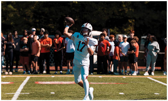A football player wearing a blue and red jersey. Description generated by AI