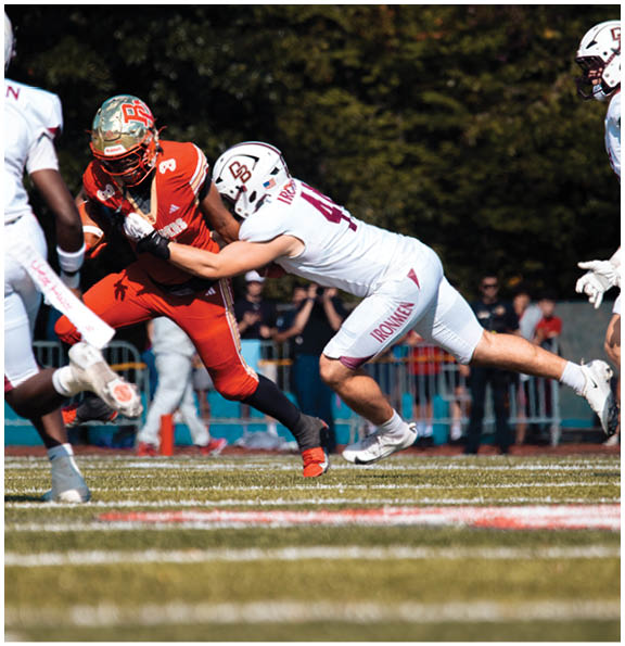 A football player wearing a blue and red jersey. Description generated by AI