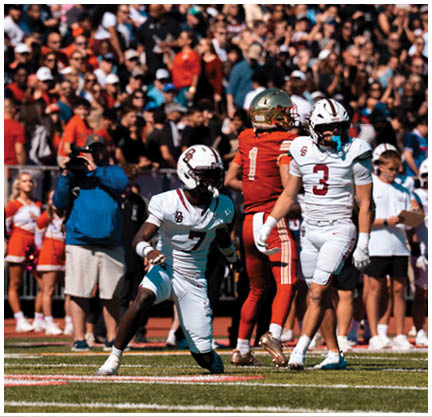 A football player running on the field. Description generated by AI