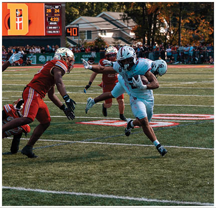 A football player running on the field. Description generated by AI