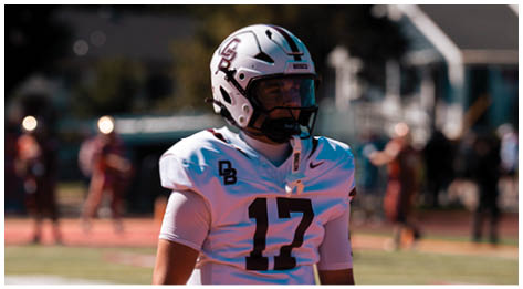 A football player wearing a blue and red jersey. Description generated by AI