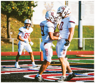 A football player wearing a blue and red jersey. Description generated by AI