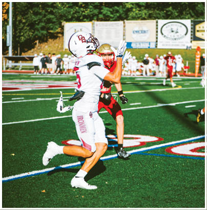 A football player wearing a blue and red jersey. Description generated by AI