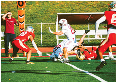 A football player wearing a blue and red jersey. Description generated by AI
